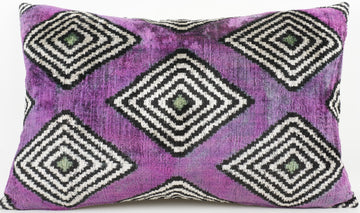 Purple pillow with black and white geometric pattern